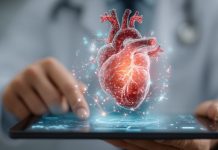 Digitale Herzdiagnostik in einer Praxissoftware: 3D-Darstellung eines menschlichen Herzens über einem Tablet, Symbol für Kardiologie, Telemedizin und digitale Patientenversorgung.